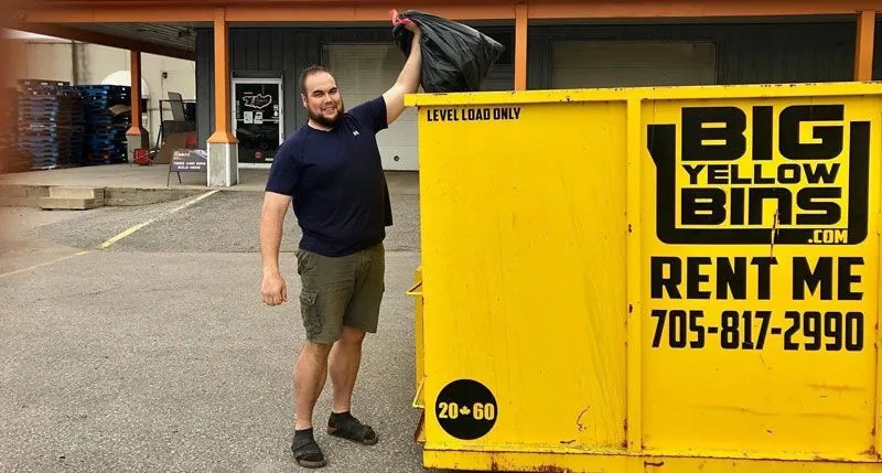 Guy throwing a trash bag